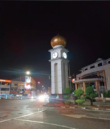 a clock tower with a gold ball on top of it at Homestay Rezeki Batu Gajah in Batu Gajah