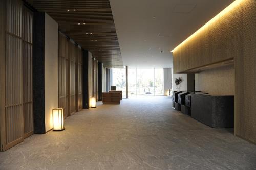 a hallway of a building with lights on the walls at Hotel Keihan Tsukiji Ginza Grande in Tokyo