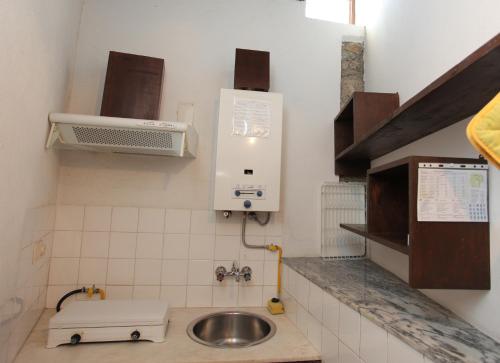 una pequeña cocina con fregadero y fregadero en Casa Grande, Turismo de Habitação e Casas de Campo, en Paços da Serra