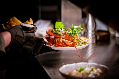 a person holding a plate of food on a counter at Ruim comfortabel appartement centrum Breda MET restaurant! in Breda