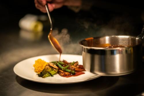 a plate of food and a pot of soup at Ruim comfortabel appartement centrum Breda MET restaurant! in Breda