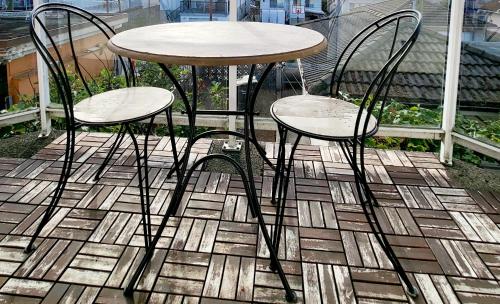 two chairs and a table on a patio at Vivi's Home in Vancouver