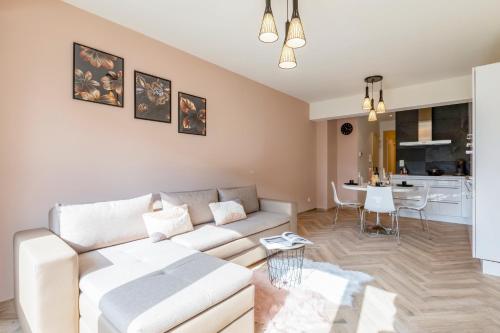 a living room with a couch and a table at EVA-Modern 2 bedroom apartment seaside Oostende in Ostend