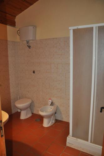 a bathroom with a toilet and a bidet at agriturismo borgo baldassarre in Cellole