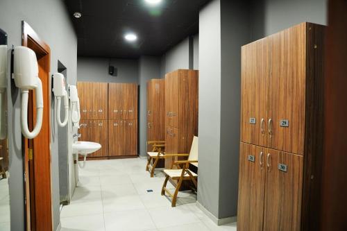 a bathroom with wooden lockers and a sink at PM Services Flora Apartments in Borovets