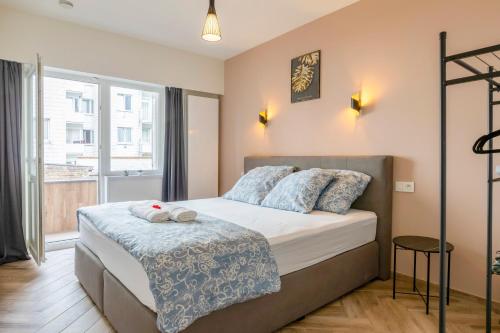 a bedroom with a bed and a large window at EVA-Modern 2 bedroom apartment seaside Oostende in Ostend