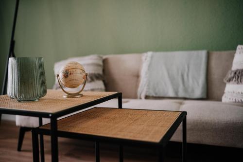 a living room with two tables and a couch at SOONWALD Studio mit Terrasse & Whirlpool in Stromberg