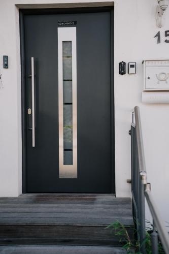a black door with a glass window on it at SOONWALD Studio mit Terrasse & Whirlpool in Stromberg