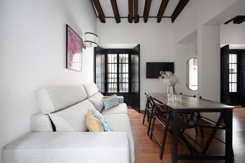 a living room with a couch and a table at Numa Seville Alegre in Seville