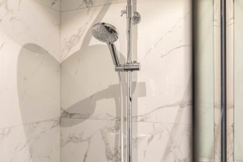 a shower with a shower head in a bathroom at EVA-Modern 2 bedroom apartment seaside Oostende in Ostend