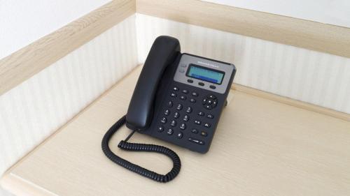 a black phone sitting on top of a box at Toyoko Inn Kumamoto Sakuramachi Bus Terminal Mae in Kumamoto