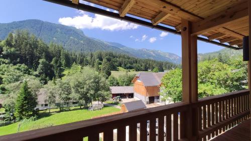 a view from the balcony of a house with mountains in the background at Burglodge Fischerkeusche in Mauterndorf