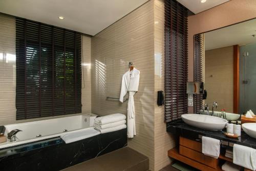 a bathroom with a tub and a sink at InterContinental Bandung Dago Pakar by IHG in Bandung