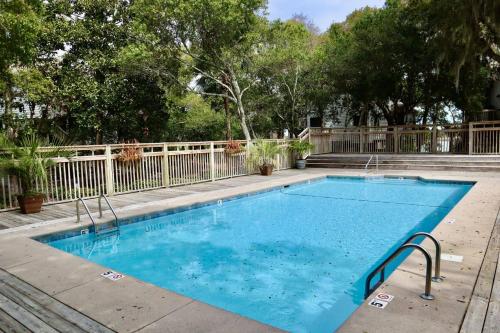 a swimming pool with blue water in a yard at Marsh Mellow in Southport