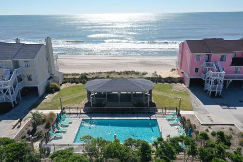 an aerial view of a pool and the beach at Saltwater Kure in Kure Beach
