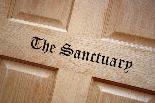 a wooden door with the scientology sign on it at B&B Dorwyn Manor in Avebury