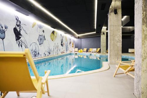 a large swimming pool with chairs and a swimming pool at Flora Apartment 423 in Borovets