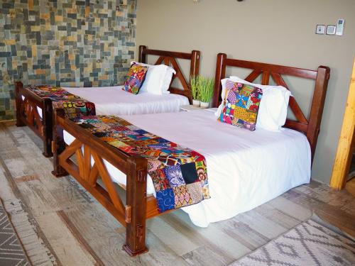 two twin beds in a room with at Wag Hill Lodge & Spa in Mwanza