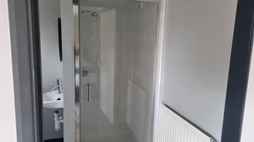 a shower with a glass door in a bathroom at Vale of York restaurant and rooms in Thirsk