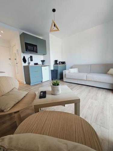 a living room with a couch and a table at Studio Saint-Laurent-Du-Var 50m de la mer in Saint-Laurent-du-Var