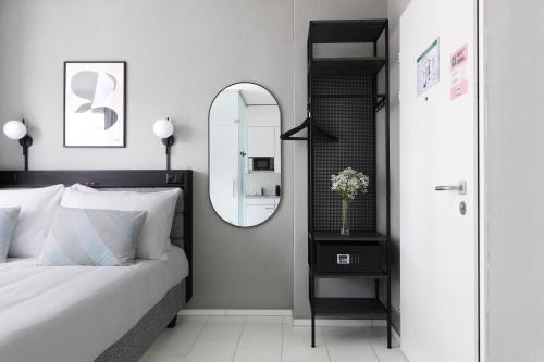 a bedroom with a bed and a mirror at Numa Zurich Turi in Zürich