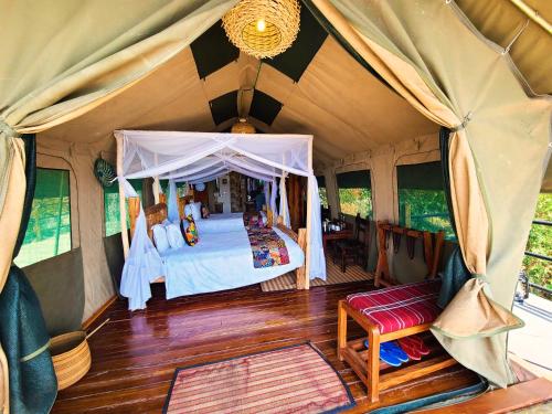 a bedroom in a tent with a bed in it at Wag Hill Lodge & Spa in Mwanza