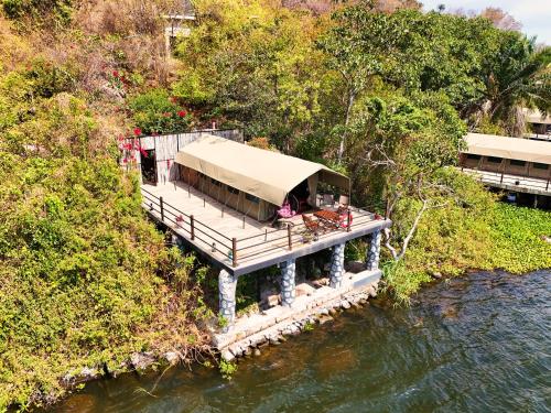 a house on a dock in the middle of a river at Wag Hill Lodge & Spa in Mwanza