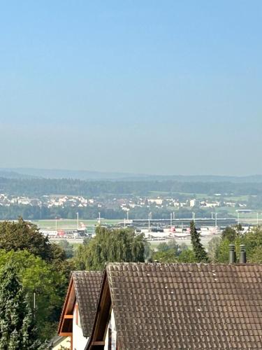 a view of the roofs of houses and an airport at Dachwohnung in Flughafennähe in Kloten