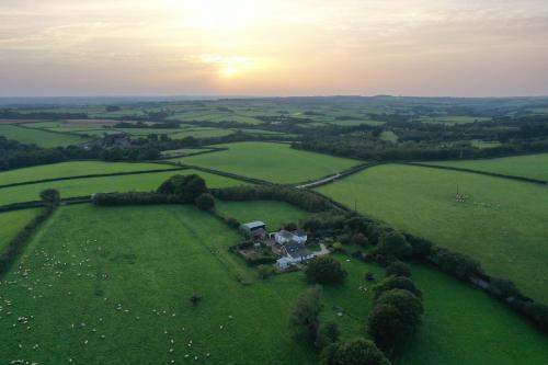 an aerial view of a farm with sheep in a field at Barn End Cottage in High Bickington
