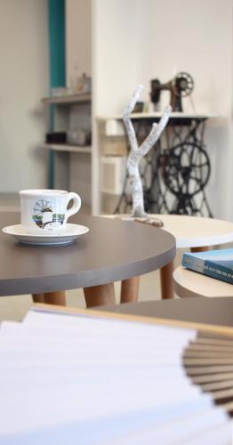a coffee cup sitting on top of a table at Irini Rooms in Naousa