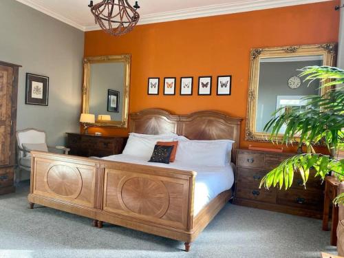 a bedroom with a large bed with an orange wall at Winter Escape with heated pool in Roby