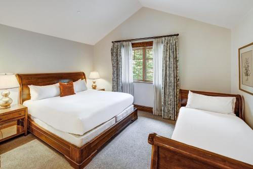 a bedroom with two beds and a window at The Arrabelle at Vail Square, a RockResort in Vail