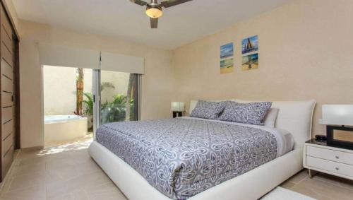 a bedroom with a bed and a bathroom with a tub at ☆ Location & Comfort ☆ Jacuzzi ☆ Luxury Condo in Tulum