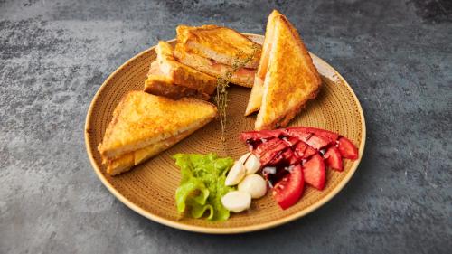 a plate of food with sandwiches and fruit on it at Konak Stella in Belgrade