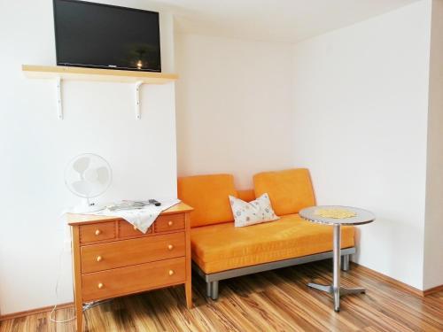 a living room with a couch and a table at Gästehaus zur weißen Rose in Furth