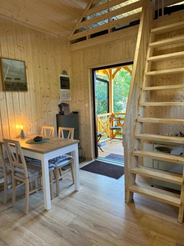 un comedor con mesa y sillas y una escalera en Islandzka chatka, en Mżyki