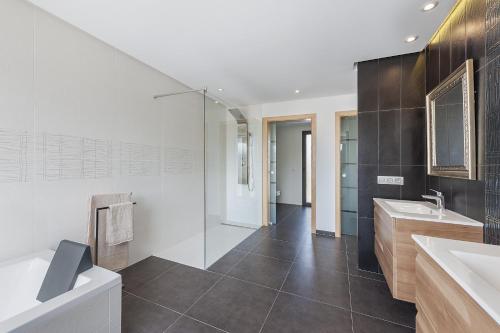 a bathroom with two sinks and a glass shower at Villa Lali in Alcudia