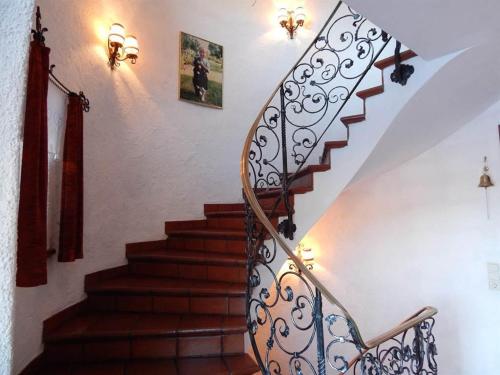 a staircase with a wrought iron railing and a stair case at Gästehaus Summer in Schruns-Tschagguns