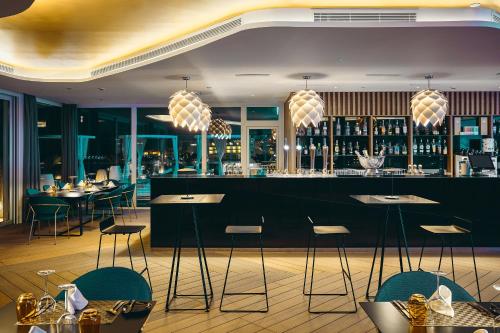 a restaurant with a bar with a view of the city at ROBINSON JANDIA PLAYA - Adults only in Morro del Jable