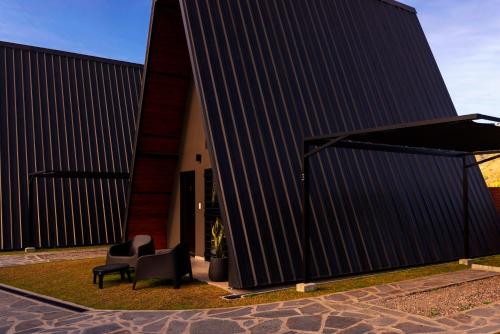 a house with a black roof and a chair at Las MORENAS in Yala