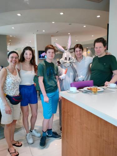 a group of people posing for a picture at a counter at Savoy Central Hotel Apartments in Dubai