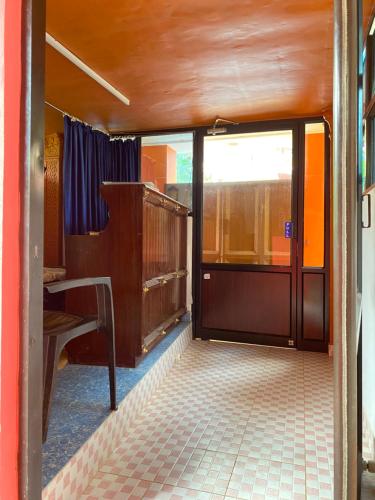 an open door to a train room with a tiled floor at Packbag Comfort Bed & Breakfast in Kovalam