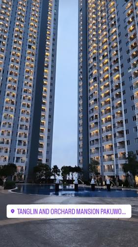 a view of two tall buildings in a city at Elegance Orchard in Surabaya