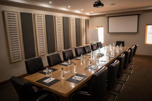 a large conference room with a long table and chairs at Africanos Country Estate in Addo
