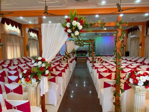 a row of tables and chairs in a banquet hall at Hotel Juli Reception in Mannar