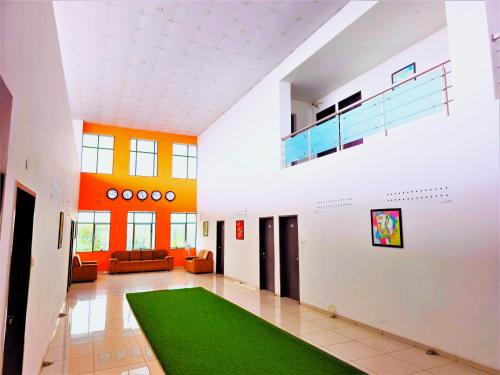 a hallway with a green rug in a building at The Grand Rio in Rajkot