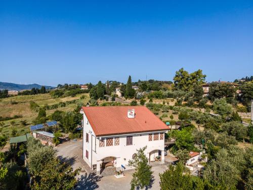 an aerial view of a white house with a red roof at Sole Verde green house in Terricciola