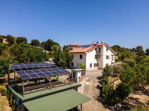 a house with a roof with solar panels on it at Sole Verde green house in Terricciola