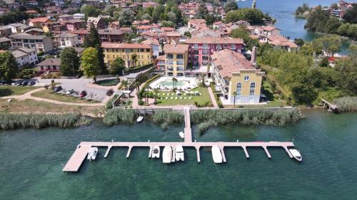 an aerial view of a house with a dock in the water at Yachting Residence in Lavena Ponte Tresa