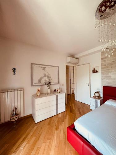 a bedroom with a bed and a white dresser at Serendipity in Bentivoglio